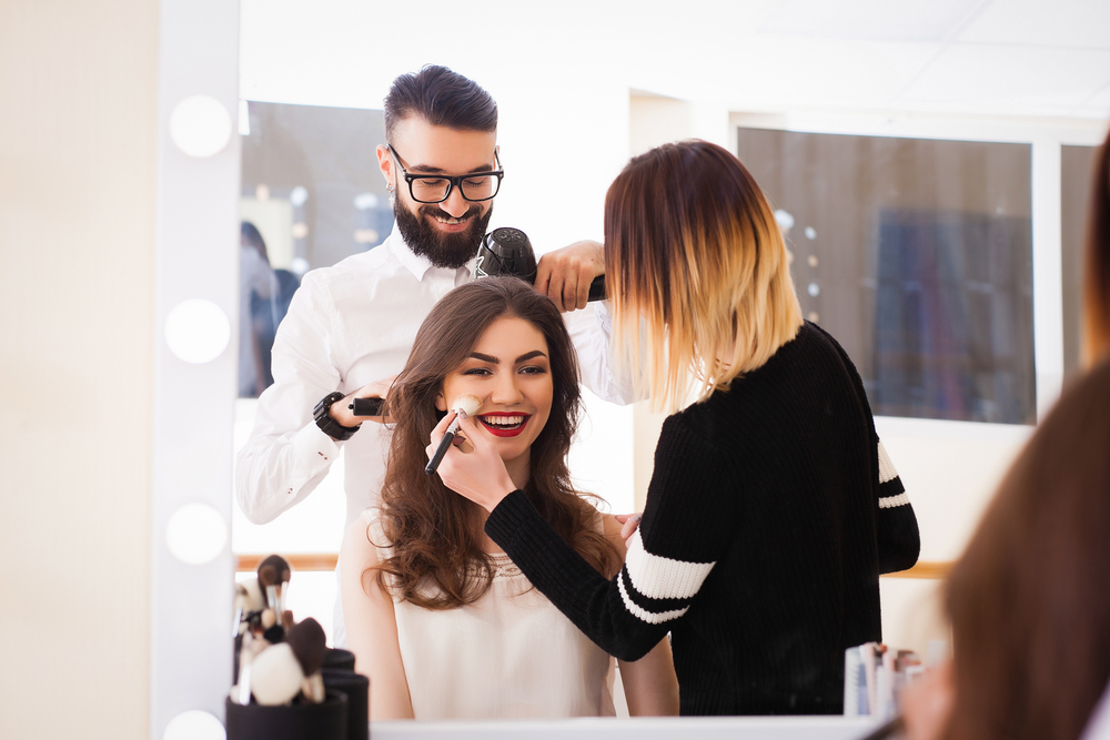 man and woman doing hair and makeup