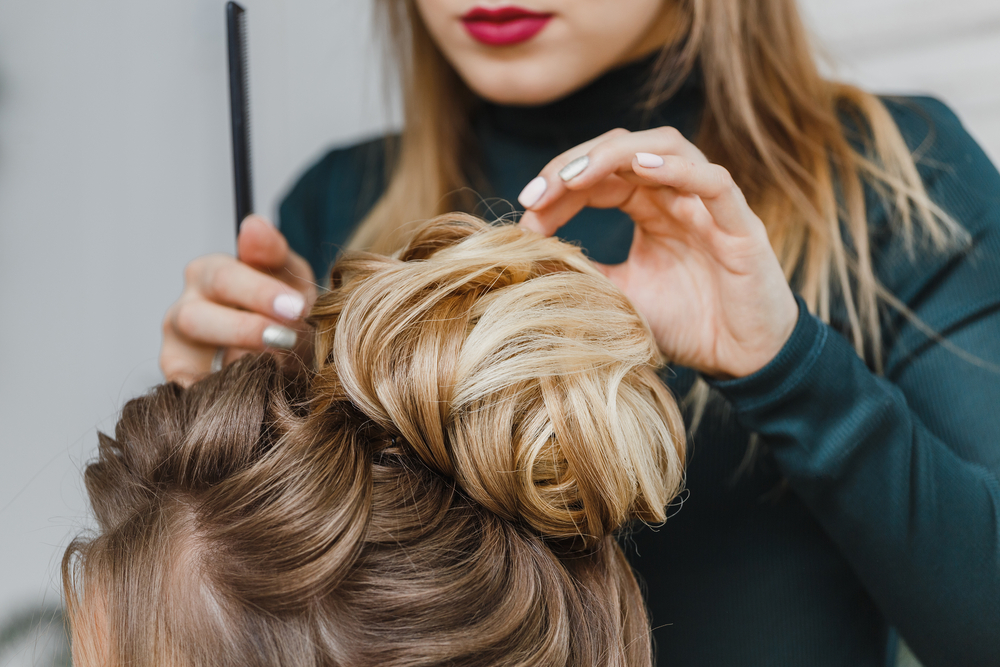 woman stylist doing an updo