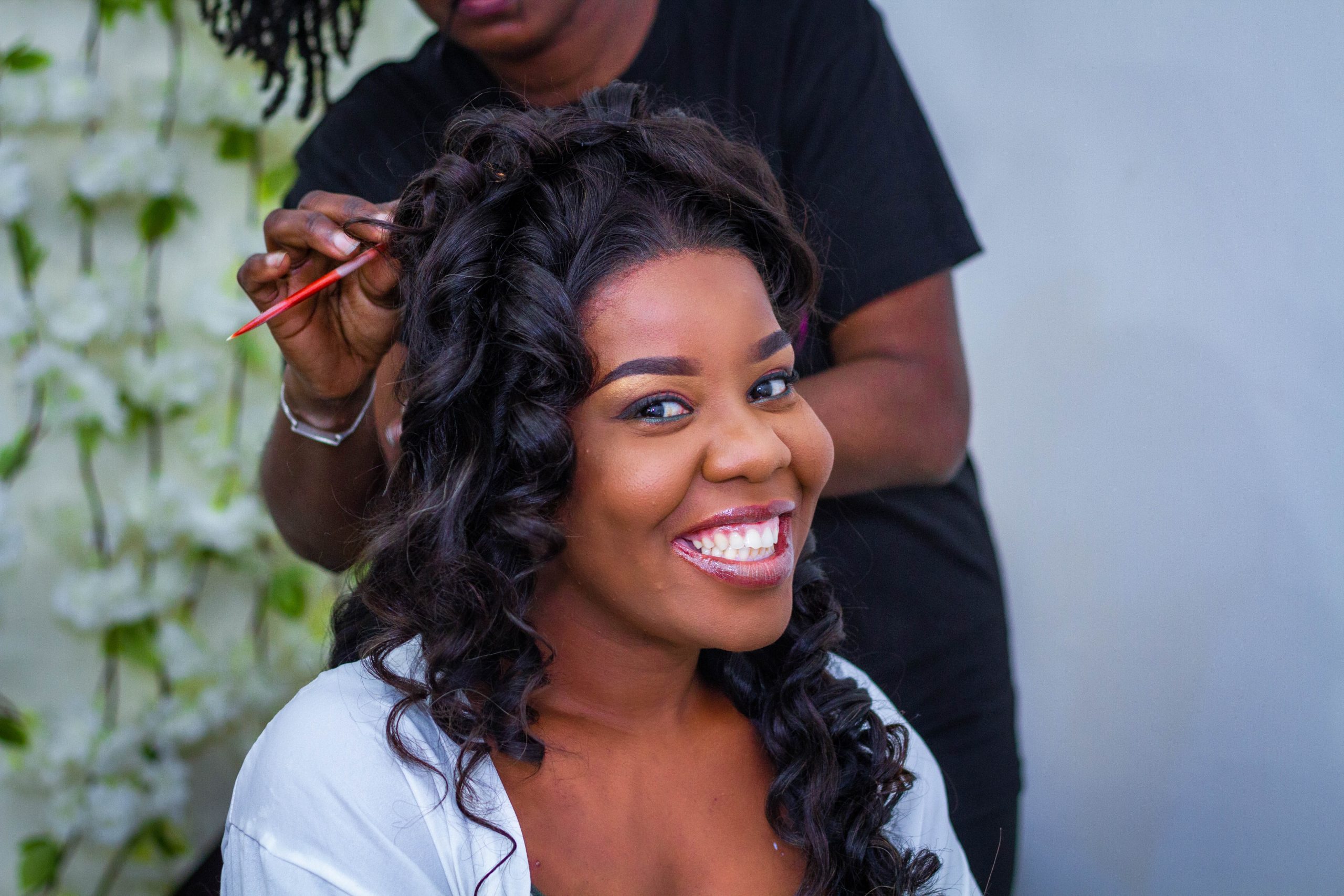 woman getting her hair styled by a professional