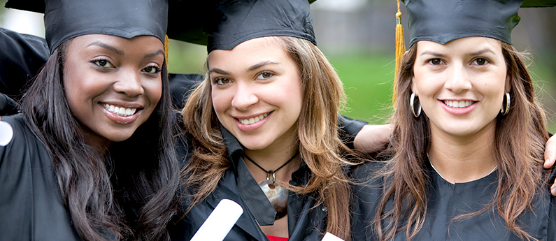 Three young woman in graduation caps and gowns