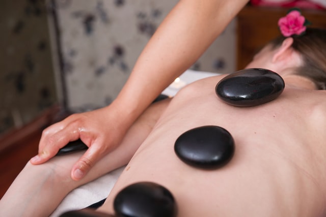 Client getting a hot stone massage
