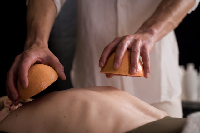 Massage therapist giving a massage to a client.